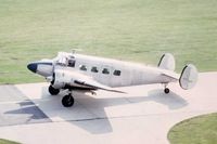UNKNOWN @ DPA - Beech 18 taxiing past the control tower - by Glenn E. Chatfield
