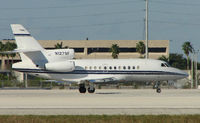 N127SF @ MIA - Falcon 900EX about to depart Miami in the mid-afternoon heat - by Terry Fletcher