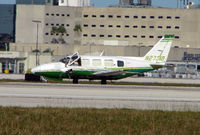 N27319 @ MIA - The mid-afternoon heat encourages the pilot to open his window whilst he waits in line for departure from Miami