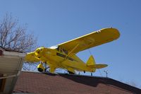 UNKNOWN @ CID - Piper Colt on top of the Flying Weenie, downtown Cedar Rapids, IA.  Even the tables have sectional charts.  Lots of airplane stuff inside - by Glenn E. Chatfield