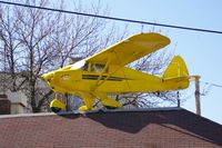 UNKNOWN @ CID - Piper Colt on top of the Flying Weenie, downtown Cedar Rapids, IA.  Even the tables have sectional charts.  Lots of airplane stuff inside
