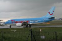G-THOP @ EGCC - Taken at Manchester Airport on a typical showery April day - by Steve Staunton
