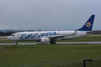 5B-DBU @ EGCC - Taken at Manchester Airport on a typical showery April day - by Steve Staunton