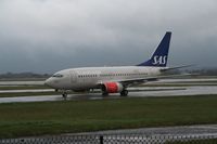 LN-RRO @ EGCC - Taken at Manchester Airport on a typical showery April day - by Steve Staunton
