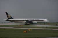 9V-SVC @ EGCC - Taken at Manchester Airport on a typical showery April day - by Steve Staunton