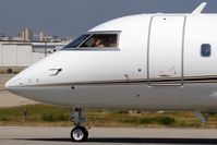 N888WS @ VNY - Close-up of Williams Sonoma 1994 Canadair Challenger CL-600-2B16 N888WS taxiing to RWY 16R for departure, with a friendly pilot waving hello, acknowleging my presence.