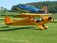 N7358H @ 2D7 - Right place at the right time.  N7358H taxiing out to depart Beach City fly-in with N3362 taking off in the background. - by Bob Simmermon