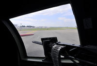 N5017N @ KAPA - Looking out port waist gunner window at engine run-up area for 17L - by John Little