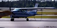 N7586V @ OAJ - Clean Cessna nearly hidden by the warbird - by Paul Perry