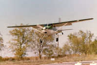 UNKNOWN @ 52F - Cessna 180 landing at the former Mangham Airport, North Richland Hills, TX - by Zane Adams