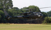 G-SIVJ - This Gazelle's down draught scatters the grass from the recently mown airstrip at Baxterley