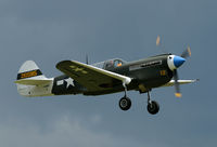 F-AZKU @ EGSU - Nice clear view of this P-40 against the upcoming thunderstorm.
