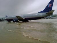 N333UA - Taxi through water after heavy rain @ OHara - by Unk