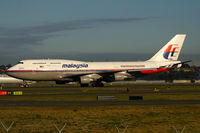 9M-MPI @ YSSY - Sun just starting to rise and cast its golden glow as she heads back to Malaysia - by Bill Mallinson