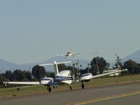 N2112F @ POC - Taxiing for take off while one is landing - by Helicopterfriend