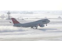 N673US @ CID - NW9980 about 3200 feet down the runway.  Wind 280@25-30 kts.  I'm glad I have my parka on! - by Glenn E. Chatfield