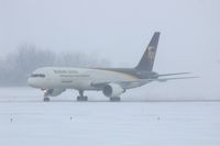 N414UP @ CID - Taxiing to cargo ramp via Alpha.  Early morning in the snow.