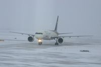 N414UP @ CID - Taxiing to cargo ramp via Alpha 4.  Early morning in the snow.