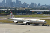 A6-EHE @ YSSY - Ethiad A340 Series 600 pulled from maintenance against the Sydney backdrop