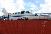 VH-ROX @ YCUD - Cessna 402A now sits WFU on top of a container at Caloundra - by Terry Fletcher