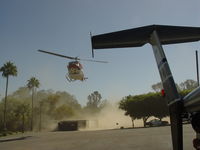 N800DM - Small dust storm created by Bell 212 landing - by Helicopterfriend