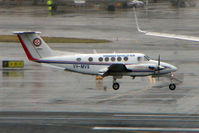 VH-MVS @ YSSY - Beech B200 landing in poor weather at Sydney