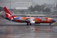 VH-VXB @ YSSY - Colourful Qantas livery brightens up a dismal Sydney day