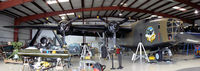 N24927 @ ADS - CAF B-24A ol 927 on jacks during winter maintenance at the Cavanaugh Flight Museum. - by Zane Adams