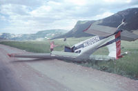N9083M - Wrecked plane found abandoned and upside down on a road outside Cody, WY in 1972. The plane apparently clipped some power lines while landing. The pilot was unhurt. The person, just clowning around in the picture, is Stephen Floethe. The aircraft apparent - by Claudia Floethe