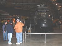 63-9676 @ FFO - A former crewman reminiscing and describing to friends the Sikorsky CH-3E Black Mariah at the USAF Museum in Dayton, Ohio. - by Bob Simmermon