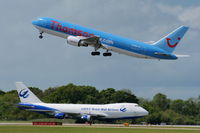 G-OBYF @ EGCC - Thomson Boeing 767 departing with B-2433 Great Wall Airlines Boeing 747 on the taxi-way - by Chris Hall