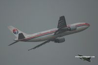 B-2318 @ ZGSZ - China Eastern Airlines taking off during a summer thunderstorm