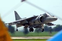 165587 @ DVN - Quad Cities Air Show; looking over the tail and between the wings of a PT-17 as the AV-8B lifts off