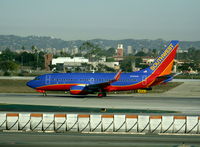 N764SW @ LAX - Southwest 2000 Boeing 737-7H4 in new colors with winglets rolling on RW 24L - by Steve Nation