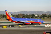 N764SW @ LAX - Southwest 2000 Boeing 737-7H4 in new colors with winglets taxiing to gate - by Steve Nation