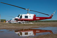 C-GJLV @ CYOJ - Delta Helicopters Bell 204 - reflection - by Dietmar Schreiber - VAP