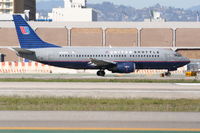 N379UA @ KLAX - United Airlines Shuttle Boeing 737-322, N379UA taxiing to 25R KLAX. - by Mark Kalfas