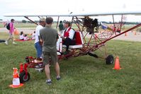 N15MY @ OSH - Breezy inventor Carl Unger seated on Mike Yankovich's machine. - by Bob Simmermon
