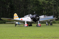 N56867 @ 42VA - A replica Aichi D3A 'Val' idles alongside a North American SNJ-4 prior to a flight demonstration. - by Dean Heald
