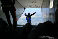 N101UV @ DED - A skydiver exits the SuperVan over Deland, FL - by Dave G
