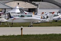 N4ZZ @ KOSH - Taxi to parking - by Todd Royer