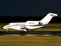 VP-CEG @ EGCC - Cessna 750 Citation 10 departing from RW 23L as the storm clouds roll in - by Chris Hall