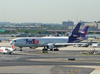 N615FE @ KEWR - A FedEx freighter navigates the crowded ramp at Newark on a hot July morning in 2009. - by Daniel L. Berek