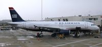 N657AW @ KMCO - At the gate at MCO on a rainy New Years. - by Kreg Anderson