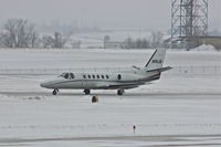 N10JA @ CID - Taxiing from PS Air to Runway 27, light snow falling