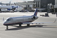 N946SW @ KLAX - SkyWest Bombardier CL-600-2B19, N946UA taxiing to gate 80 KLAX. - by Mark Kalfas