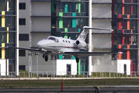 OE-FCB @ EGLC - Austrian Cessna 510 Mustang lands against the distinctive London City Airport background - by Terry Fletcher