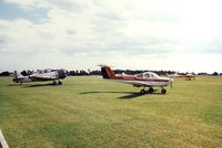 G-BJUS @ EGSE - A visitor from The Panshanger School of Flying. Harvard G-BICE in the background. - by GeoffW