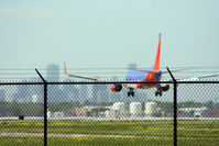 N798SW @ KHOU - B737 touches down on 30L with downtown in front of him. - by Darryl Roach