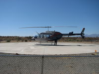 N600WP - Los Angeles Department of Water and Power Helicopter Zero Whiskey Papa on the pad at the Adelanto Converter Station.  Once upon a time we patrolled power lines on horse back.  How times have changed. - by Roy Snyder